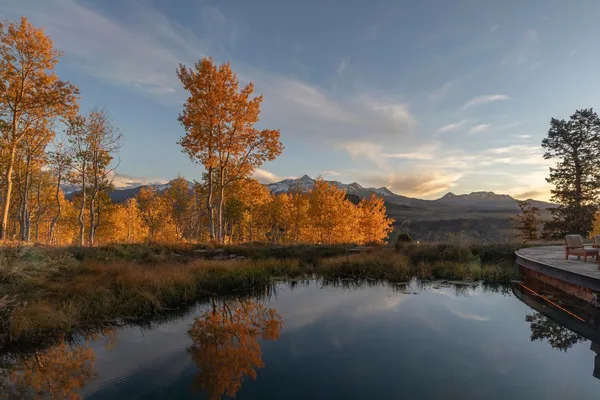 a view of a house with backyard and patio