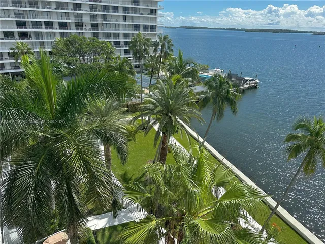 a kitchen with granite countertop a sink and a white wooden cabinets