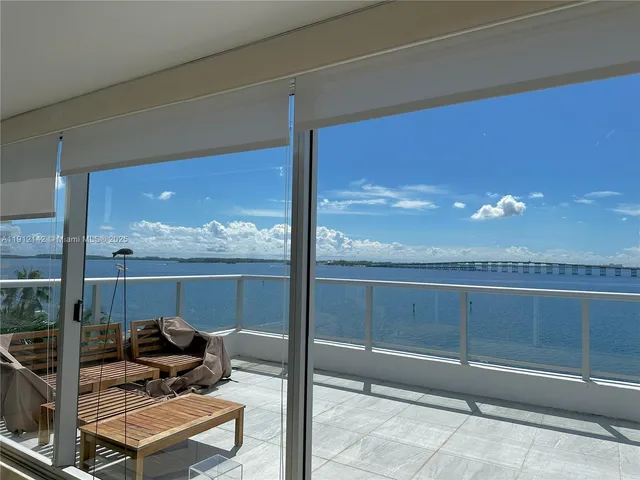 a bathroom with a light fixture and a lake view