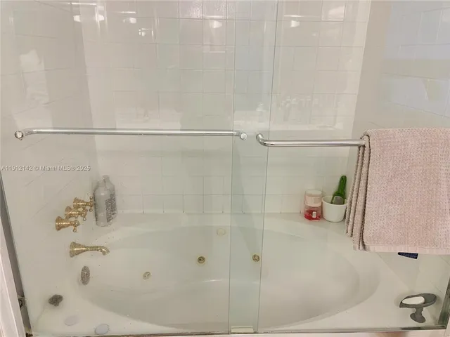 a view of a tennis ground with large trees