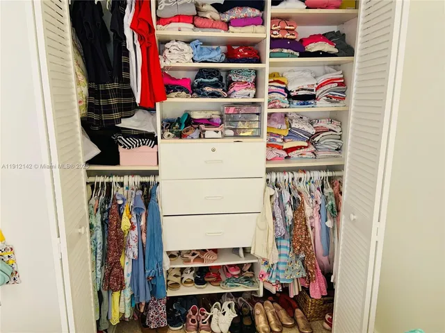 a living room with furniture and floor to ceiling windows