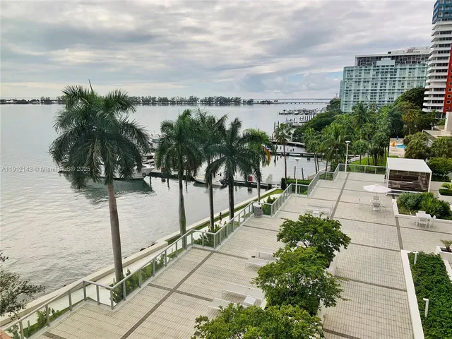 a view of a city with tall buildings and a big yard