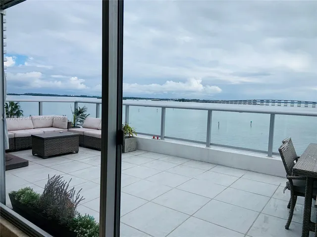 a outdoor dining space with furniture and a potted plant