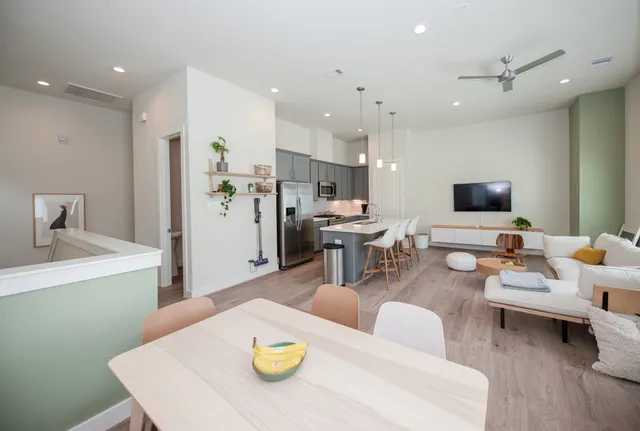 a living room with furniture and kitchen view