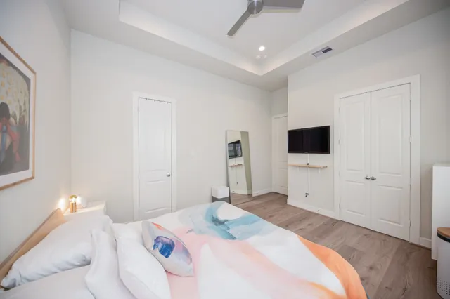 a bedroom with a bed and a flat screen tv