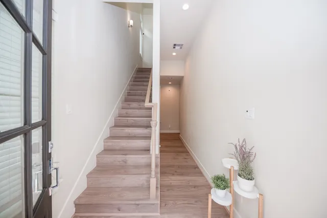 a view of entryway and hall with wooden floor
