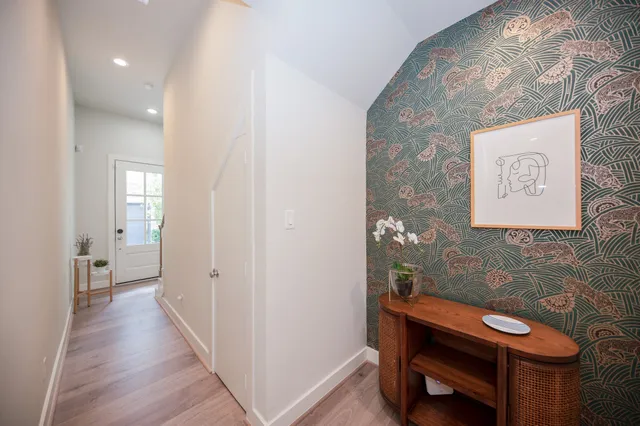 a view of a hallway with furniture