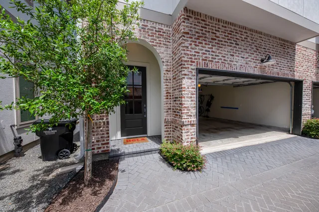 a front view of a house with potted plants