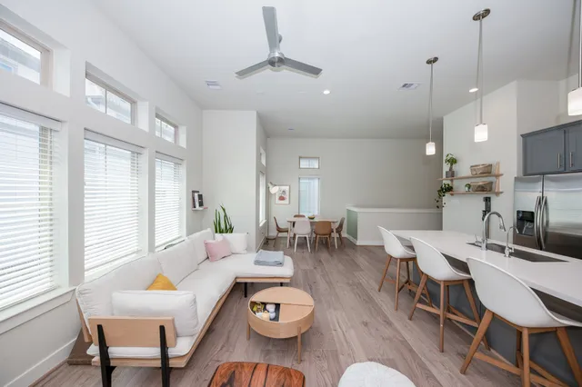 a living room with furniture a window and a table