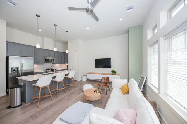 a living room with lots of furniture and a flat screen tv