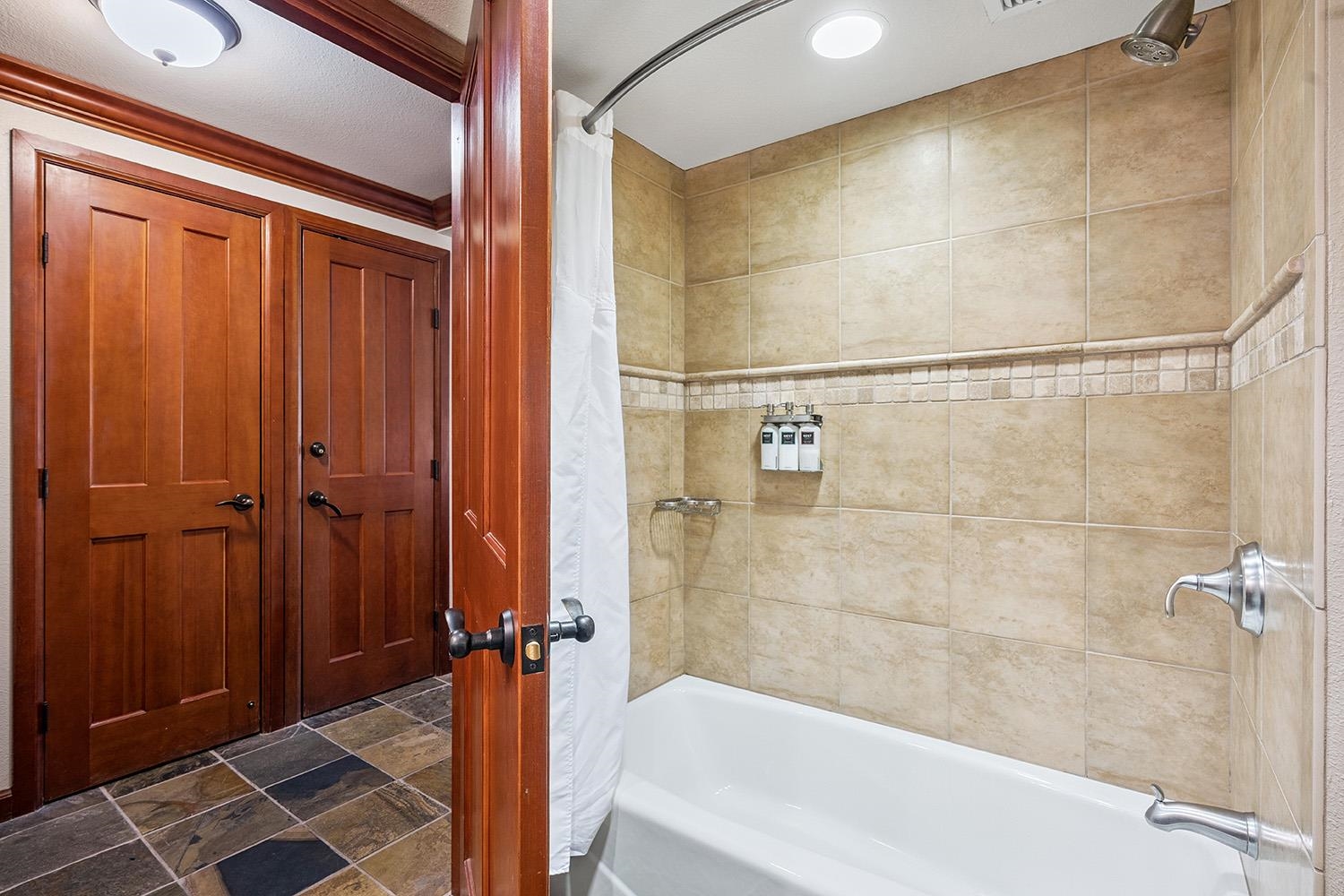 400 Resort Road, Unit 236 Olympic Valley, CA 96146 - Photo 12 of 25 a bathroom with a bathtub and a shower