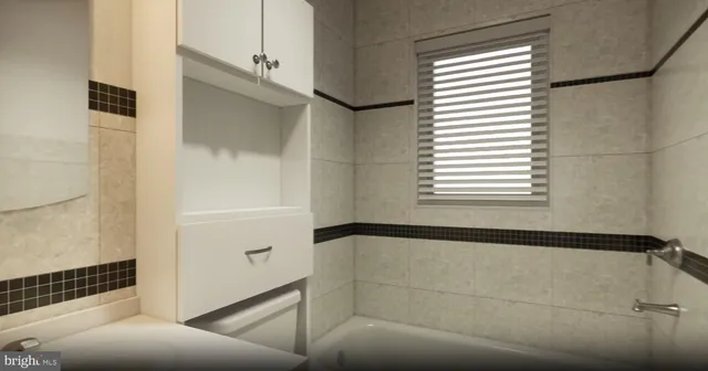 a bathroom with a bathtub and shower