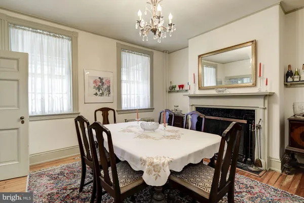 a spacious bedroom with a bed a clock and a large mirror on the dresser