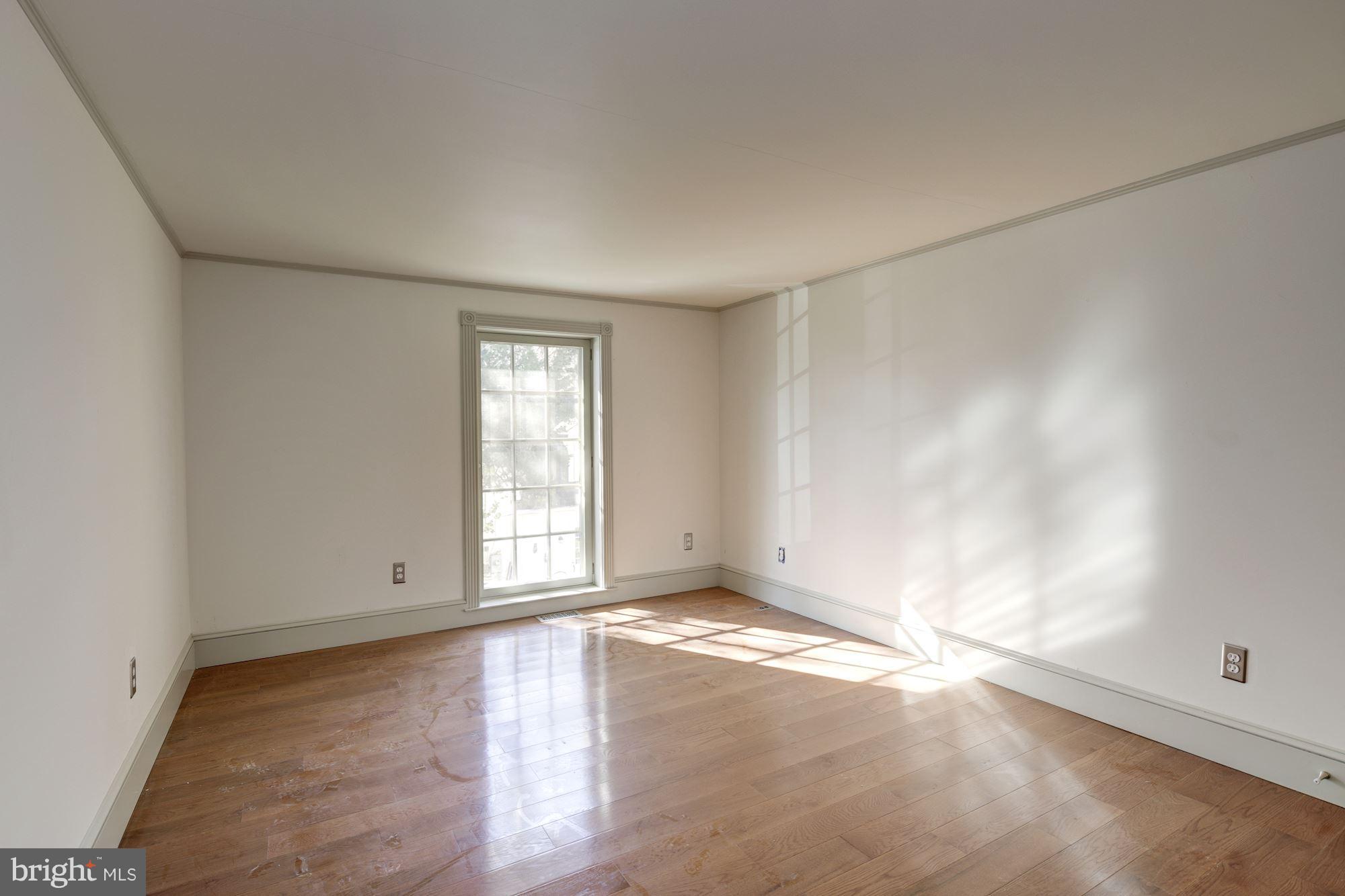 16449 Ed Warfield Road Woodbine, MD 21797 - Photo 67 of 102 an empty room with wooden floor and windows