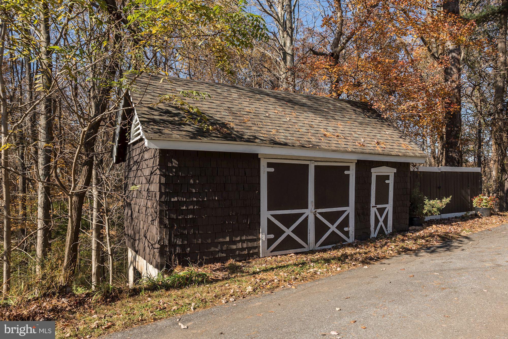 16449 Ed Warfield Road Woodbine, MD 21797 - Photo 88 of 102 a front view of a house with basket ball court and garage