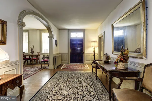 a living room with furniture a fireplace a rug and a window