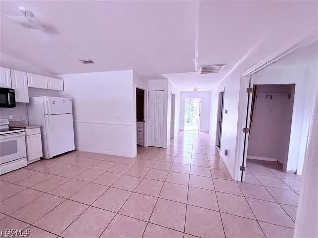 a view of a refrigerator and window in a kitchen