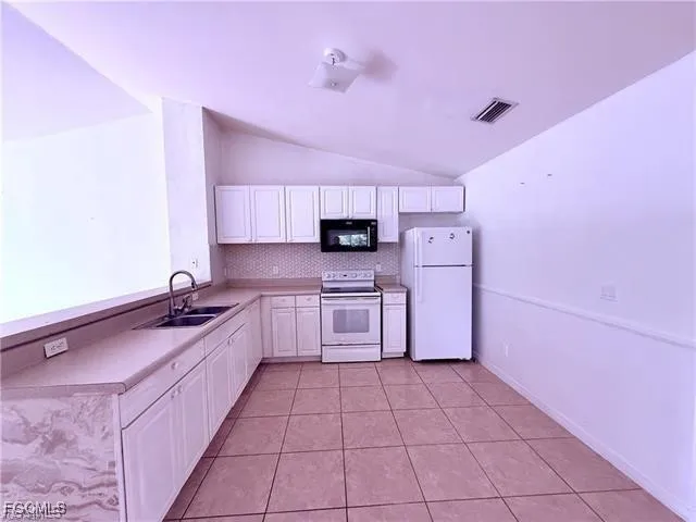 a kitchen with stainless steel appliances a sink cabinets and a counter top space