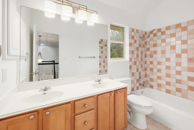 an empty room with chandelier fan