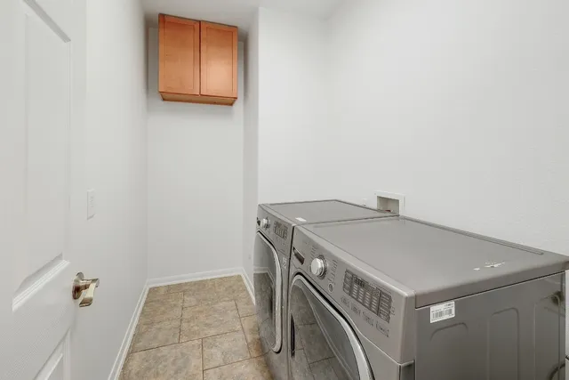 a view of a backyard with a large tree and wooden fence