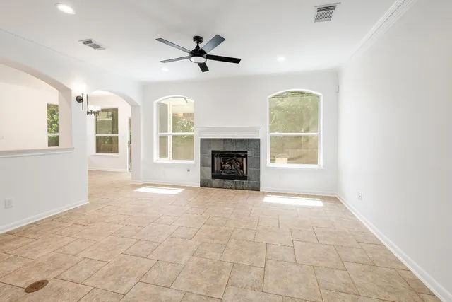 a view of an empty room with a fireplace and a window