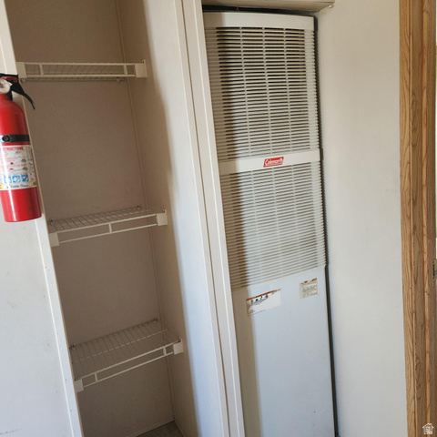 3760 Gold Ridge Drive, Unit 82 Magna, UT 84044 - Photo 16 of 29 Vertical furnace unit by Coleman, featuring a white louvered grille
