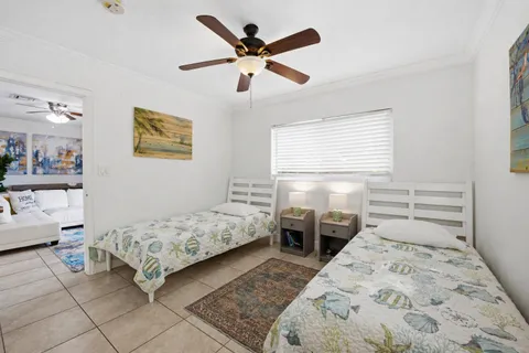 a bedroom with two beds and a window