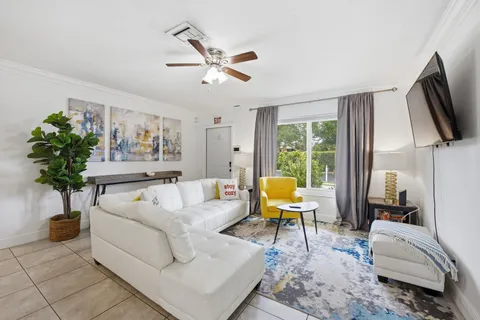 a living room with furniture and a flat screen tv