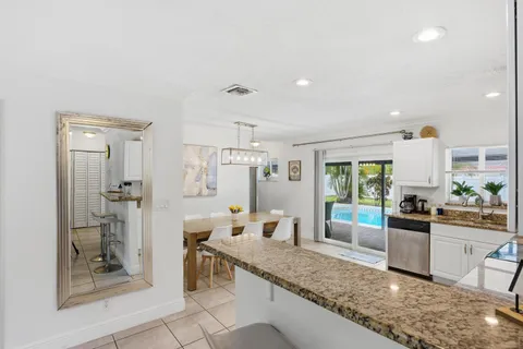 a large kitchen with a counter space a sink and stainless steel appliances