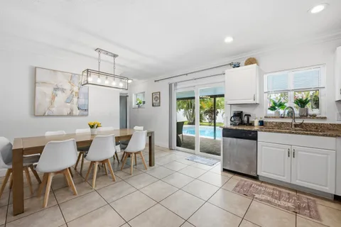a view of kitchen with granite countertop cabinets table and chairs