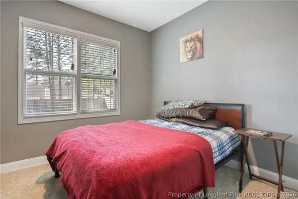 a bedroom with a bed and a painting on the wall