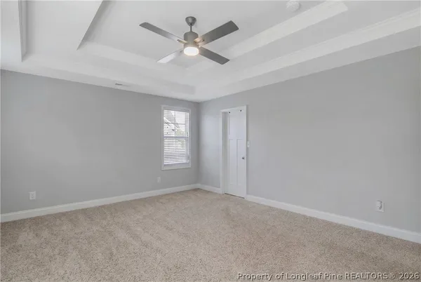 an empty room with chandelier fan