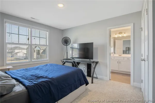 a bedroom with a bed and a flat screen television