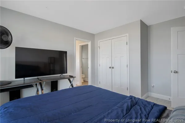 a bed sitting in a bedroom next to a window