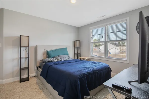 a bathroom with a double vanity sink toilet and a mirror
