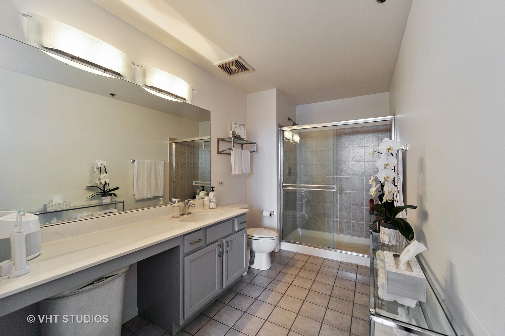 933 West Van Buren Street, Unit 612 Chicago, IL 60607 - Photo 11 of 17 a bathroom with a sink a toilet and shower