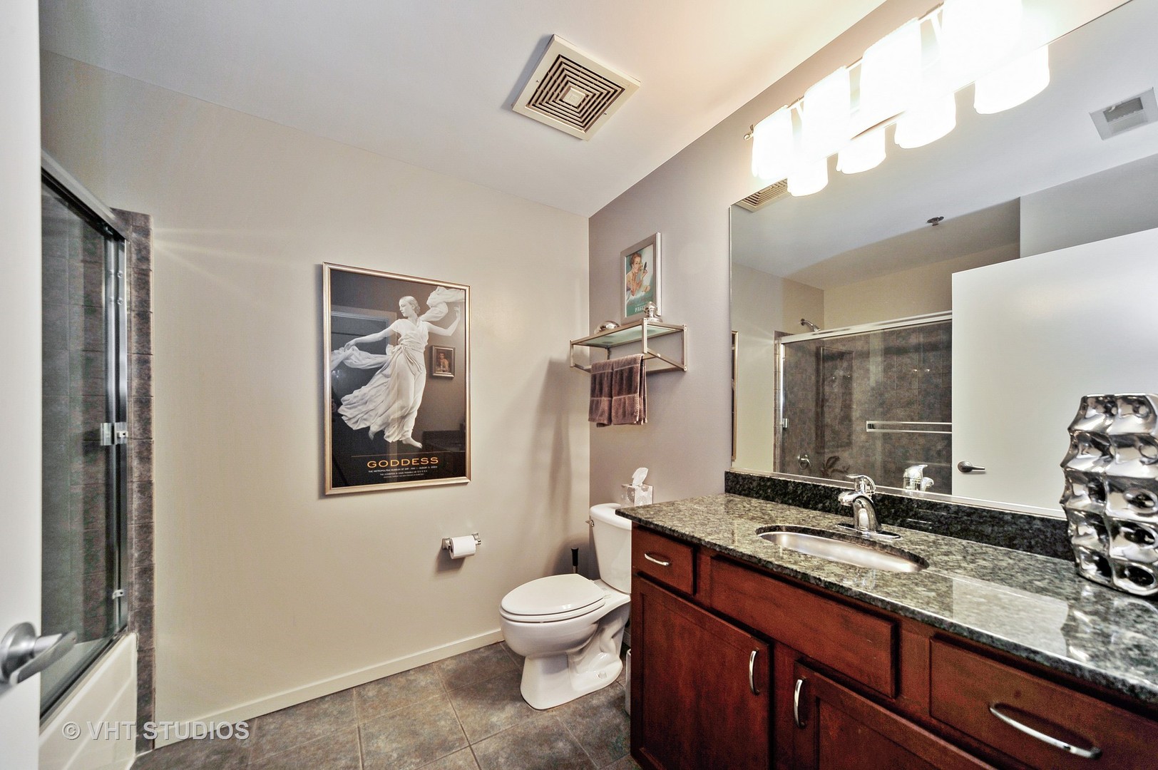 933 West Van Buren Street, Unit 612 Chicago, IL 60607 - Photo 13 of 17 a bathroom with a toilet sink and mirror
