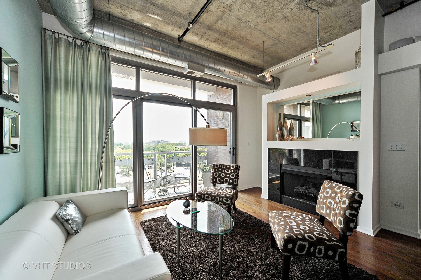 933 West Van Buren Street, Unit 612 Chicago, IL 60607 - Photo 4 of 17 a living room with furniture and a fireplace