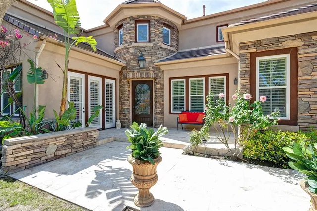a view of a brick house with potted plants