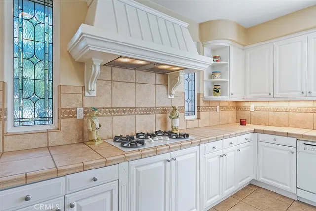 a dining room with furniture a chandelier and wooden floor