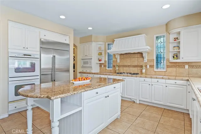 a dining room with furniture a chandelier and wooden floor