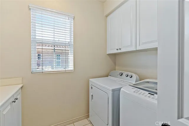 a view of a patio with a table and chairs under an umbrella