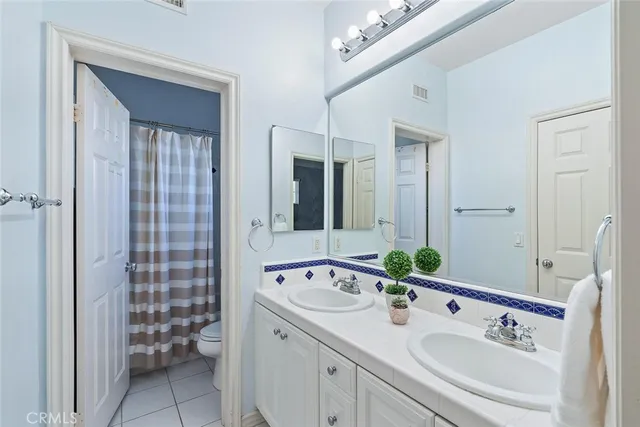 a patio with wooden floor a yard a table and chairs