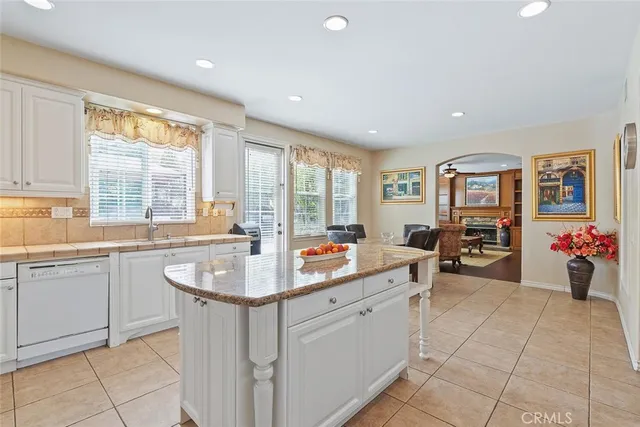a living room with furniture a table and a large window