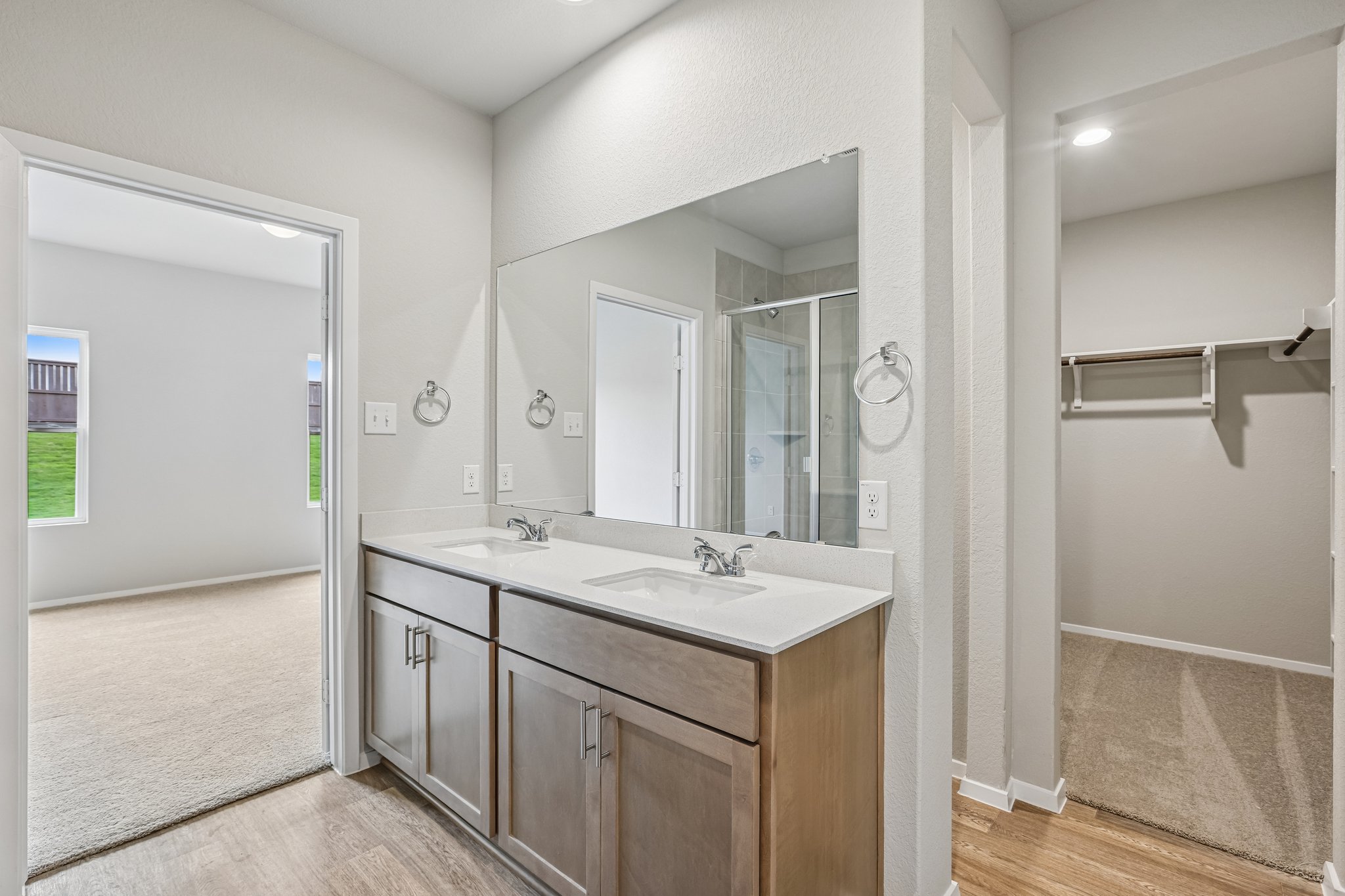 5513 Sacra Cove Austin, TX 78747 - Photo 21 of 37 a bathroom with a sink a mirror and a shower