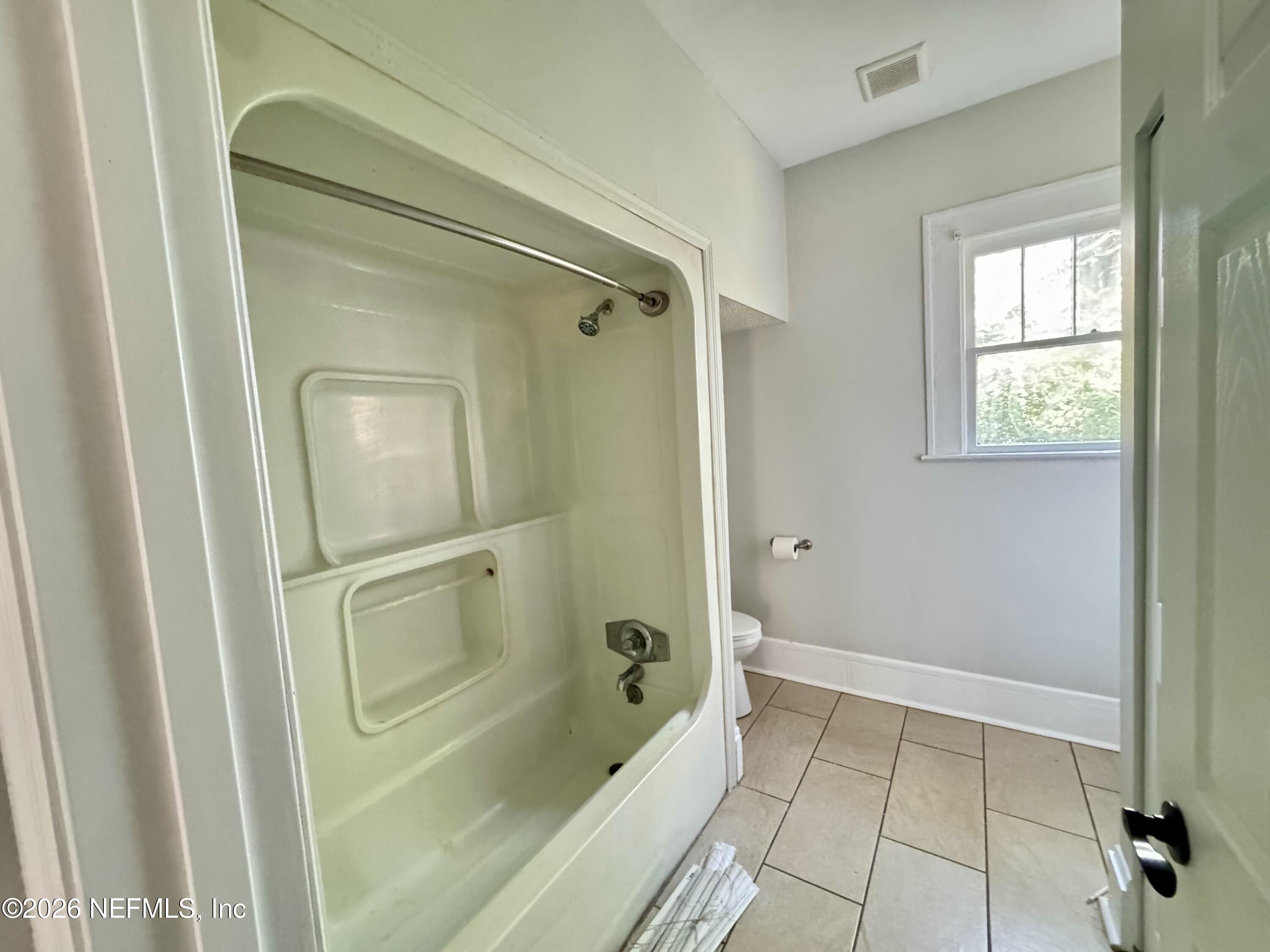 3032 Rayford Street Jacksonville, FL 32205 - Photo 13 of 17 a bathroom with a bathtub and a shower