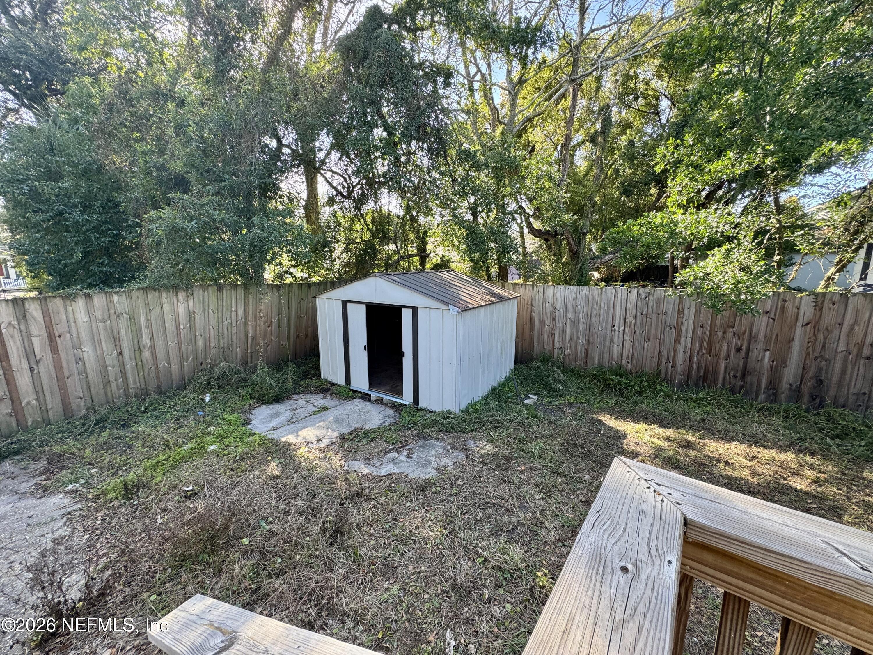 3032 Rayford Street Jacksonville, FL 32205 - Photo 15 of 17 a view of a backyard with large trees and wooden fence