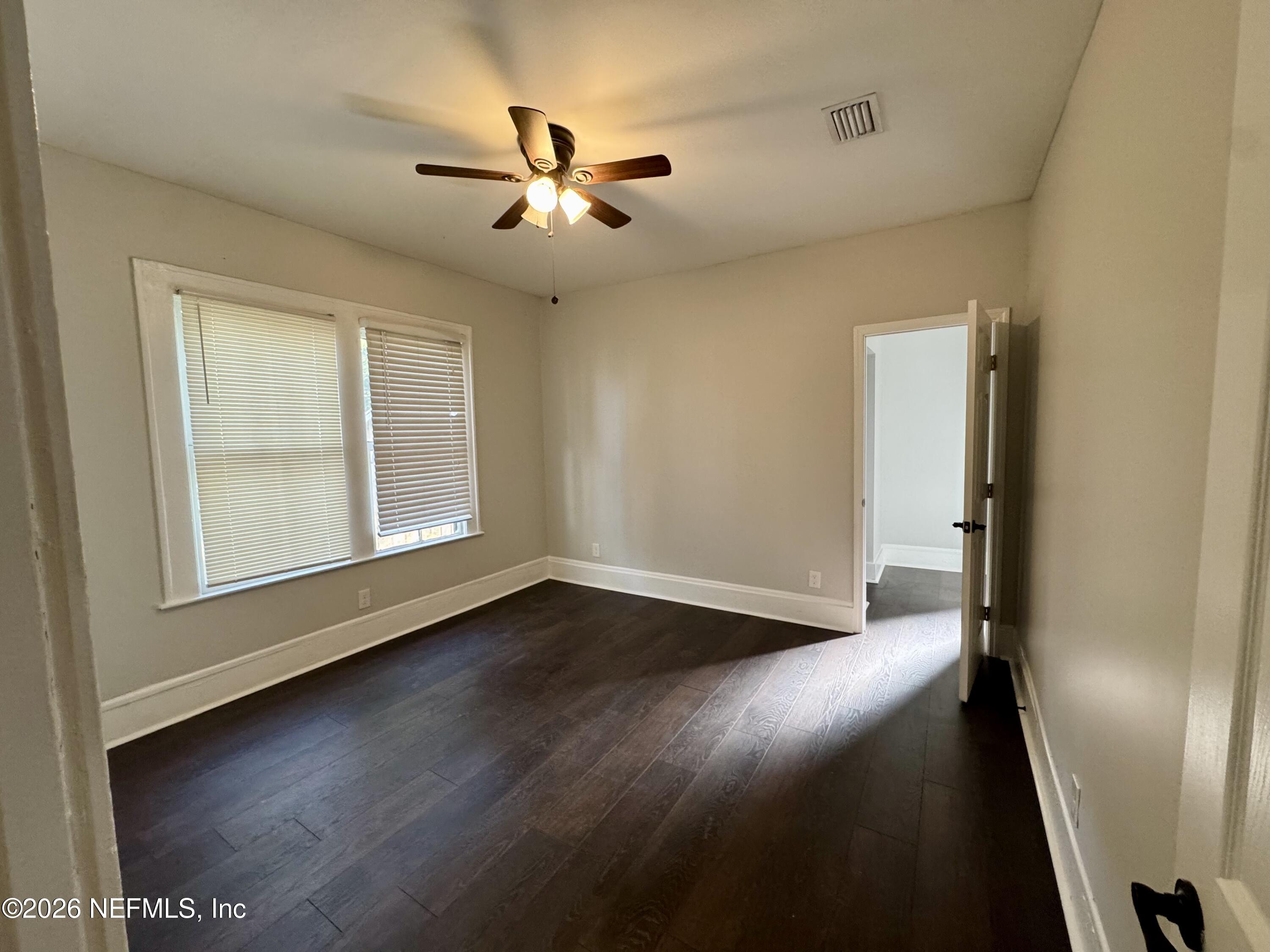 3032 Rayford Street Jacksonville, FL 32205 - Photo 8 of 17 a view of an empty room with wooden floor and a window