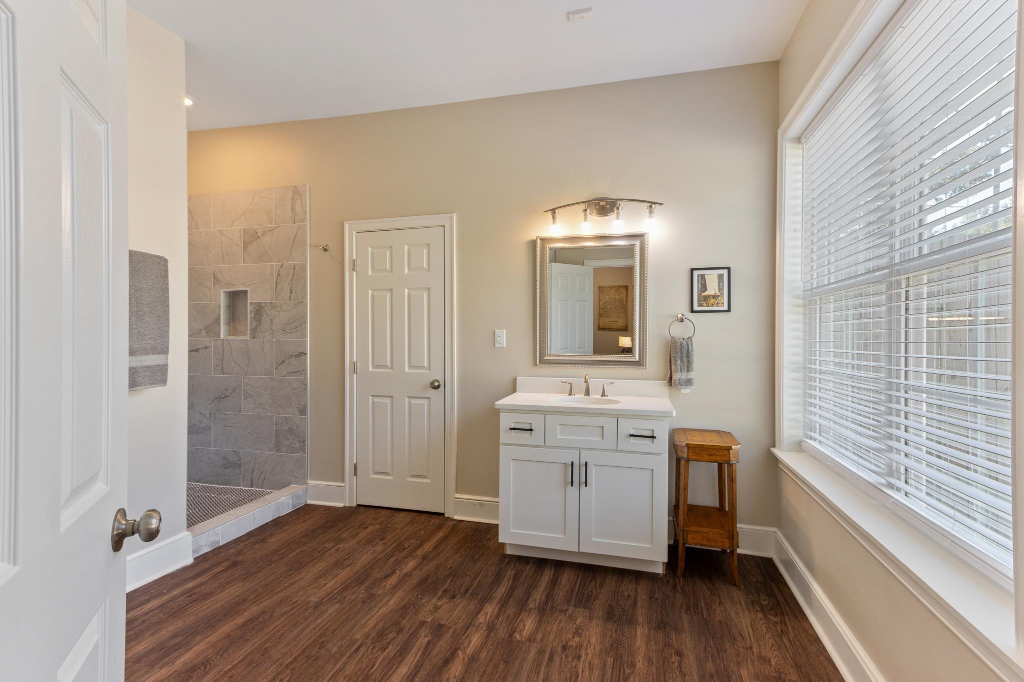 4775 Macon Road Memphis, TN 38122 - Photo 11 of 31 a bathroom with a sink a mirror and shower