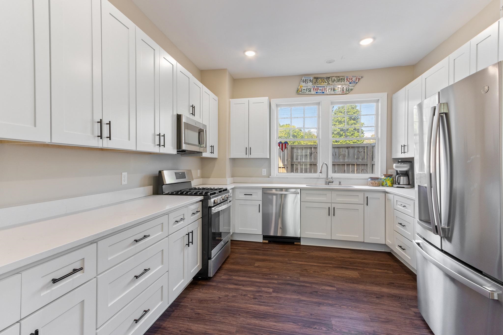 4775 Macon Road Memphis, TN 38122 - Photo 15 of 31 a kitchen with stainless steel appliances granite countertop a refrigerator sink and white cabinets